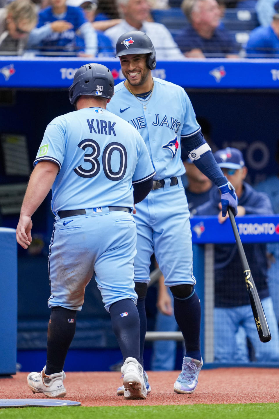 Toronto Blue Jays' Alejandro Kirk (30) celebrates with teammate George Springer (4) after scoring against the Washington Nationals during fourth inning MLB interleague baseball action in Toronto on Wednesday, Aug. 30, 2023. (Andrew Lahodynskyj/The Canadian Press via AP)