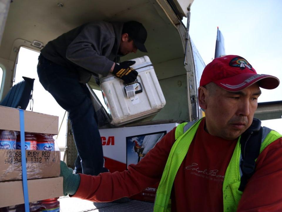 Workers unloading bypass mail in Bethel, Alaska.