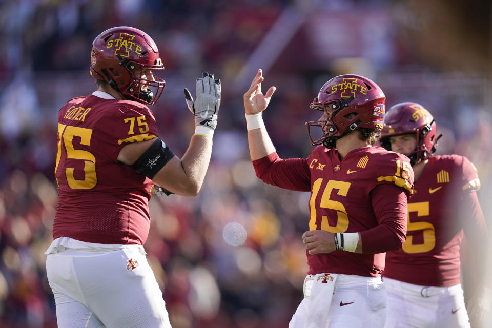 Iowa State quarterback Brock Purdy (15) celebrates with teammate Sean Foster (75) after throwing a touchdown pass during the first half of an NCAA college football game against Oklahoma State, Saturday, Oct. 23, 2021, in Ames, Iowa. (AP Photo/Charlie Neibergall)