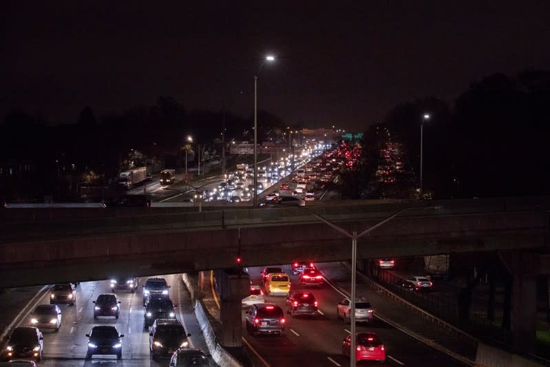 Lights illuminate the roadway as cars sit in traffic to depart New York City the day before the Thanksgiving holiday in New York