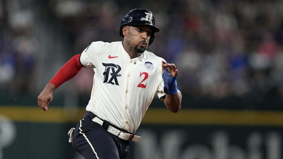 Texas Rangers' Marcus Semien advances to third on a single by Corey Seager during the sixth inning of the team's baseball game against the Seattle Mariners, Friday, June 2, 2023, in Arlington, Texas. (AP Photo/Tony Gutierrez)