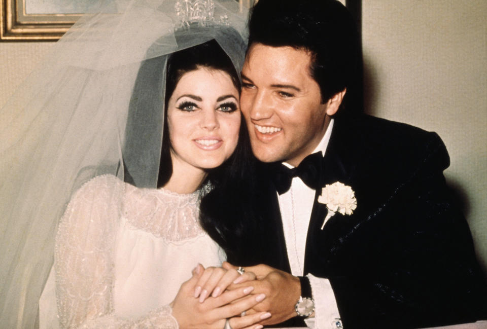 Priscilla and Elvis embracing at their wedding