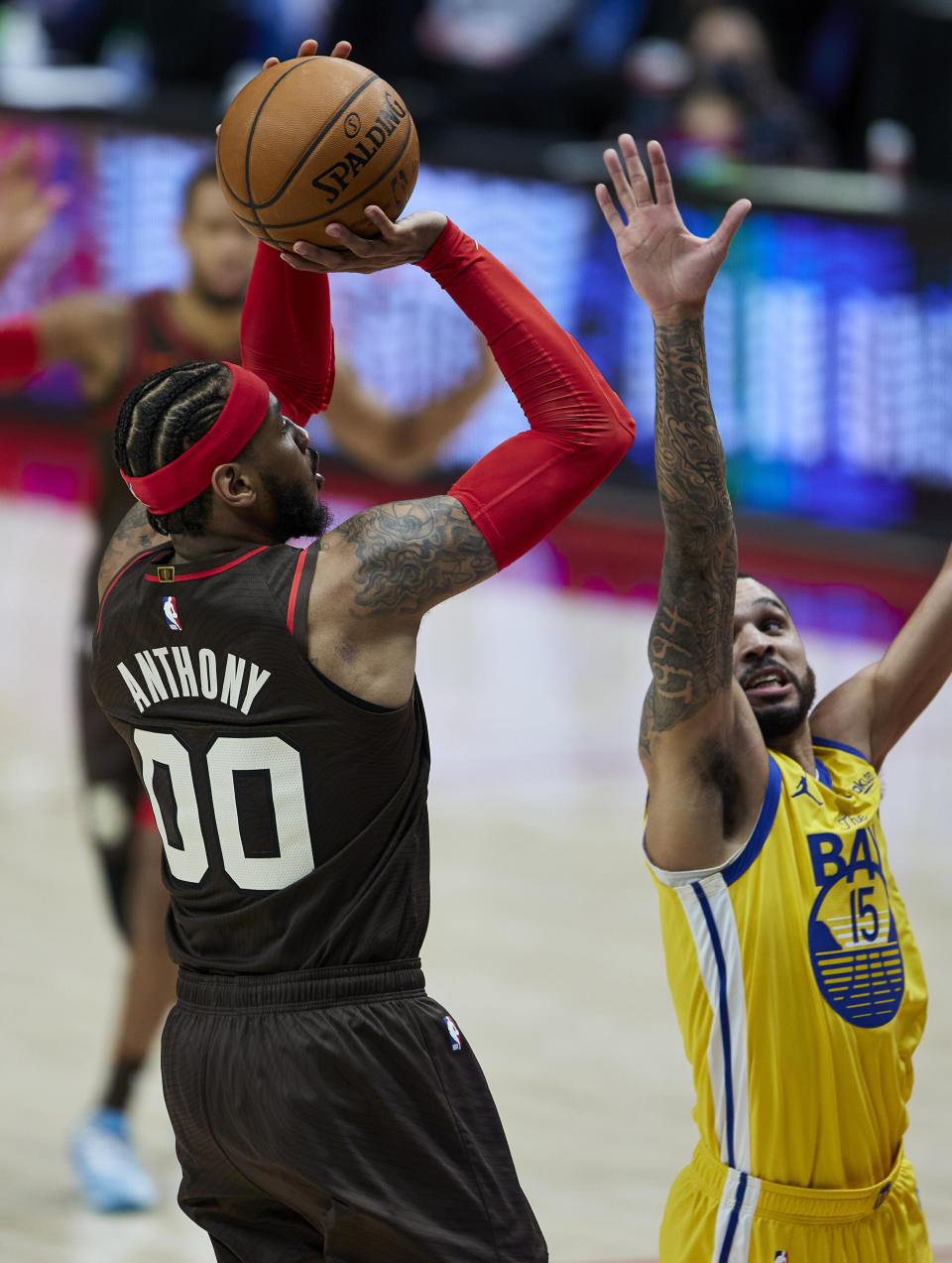 Portland Trail Blazers forward Carmelo Anthony, left, shoots over Golden State Warriors guard Mychal Mulder during the second half of an NBA basketball game in Portland, Ore., Wednesday, March 3, 2021. (AP Photo/Craig Mitchelldyer)