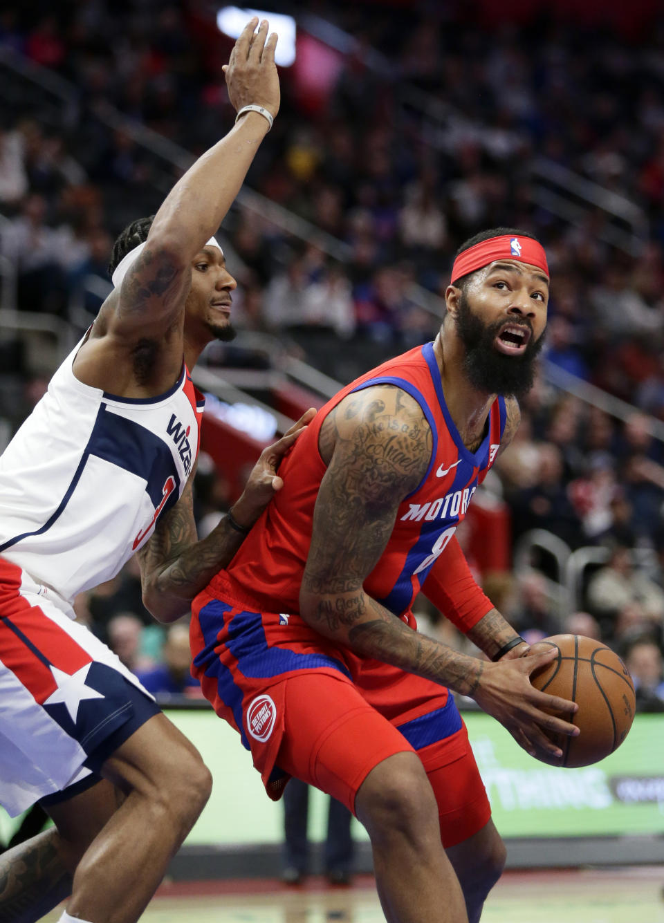 Detroit Pistons forward Markieff Morris (8) goes to the basket against Washington Wizards guard Bradley Beal (3) during the first half of an NBA basketball game Thursday, Dec. 26, 2019, in Detroit. (AP Photo/Duane Burleson)