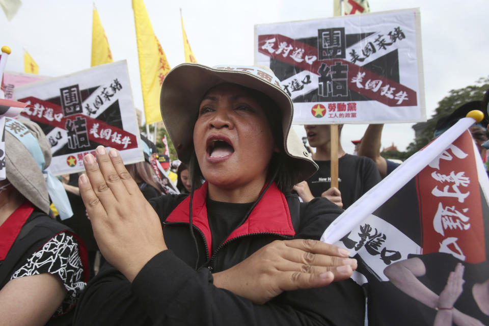 A participant shouts slogans during a protest to oppose the import of U.S. pork in Taipei, Taiwan, Sunday, Nov. 22. 2020. Thousands of people marched in streets on Sunday demanding the reversal of a decision to allow U.S. pork imports into Taiwan, alleging food safety issues. (AP Photo/Chiang Ying-ying)