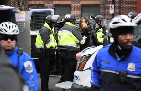 A protester is detained by police during protests near the inauguration of President-elect Donald Trump in Washington, DC, U.S., January 20, 2017. REUTERS/Bryan Woolston - RTSWIOS