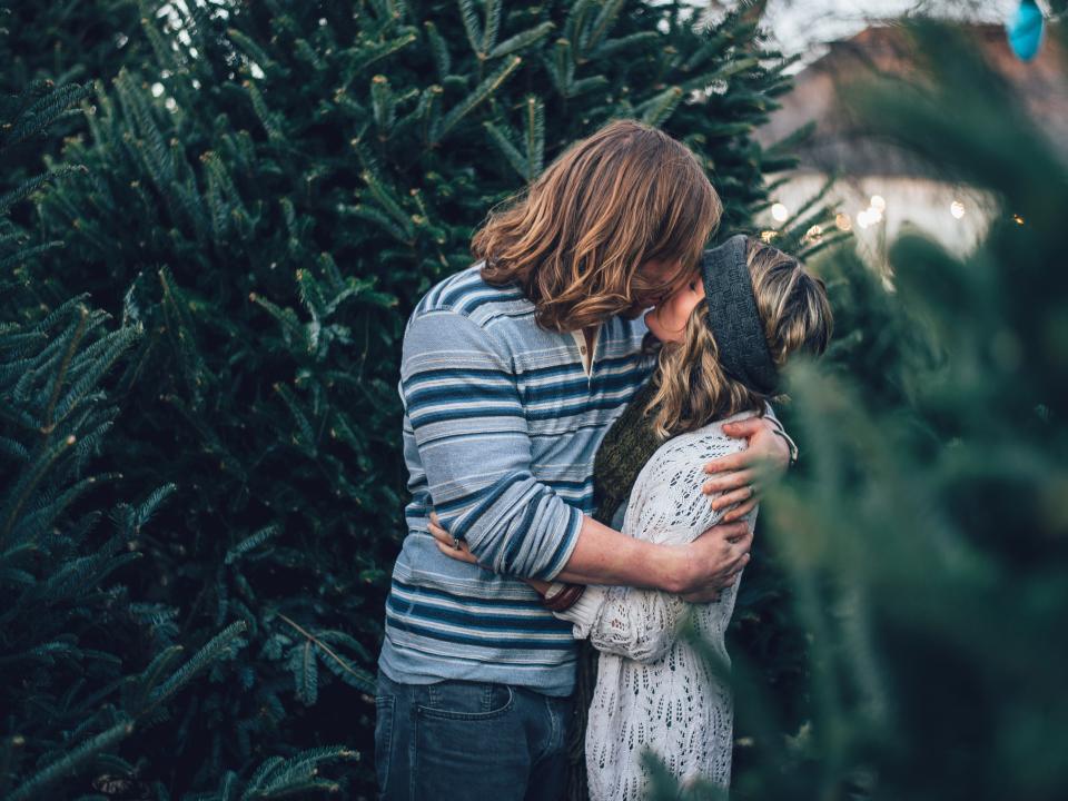 couple kissing christmas tree