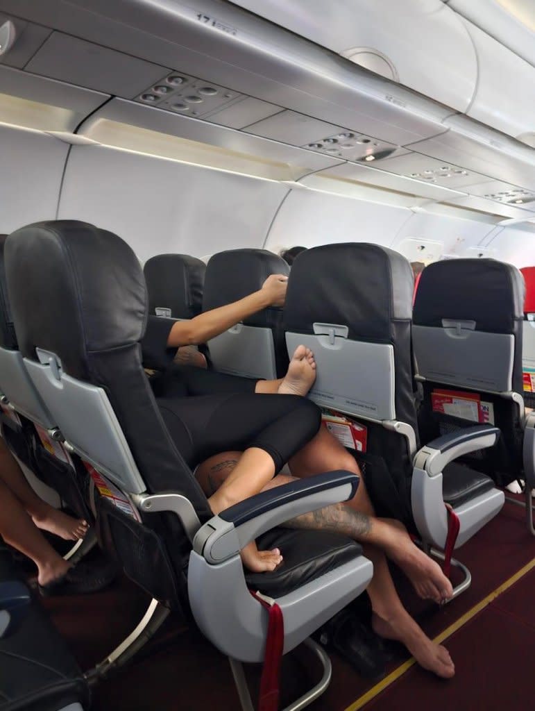 “Can’t believe my view on the plane. It was like this the whole 4 hour flight,” wrote poster Flea in the caption to the photos of the sky-high spooning session, which occurred aboard an unspecified flight. X/@babyibeenajoint