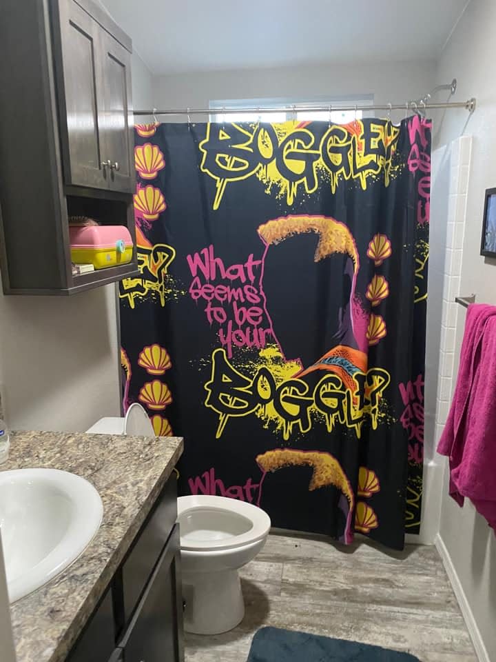 bathroom in mobile home with colorful shower curtain