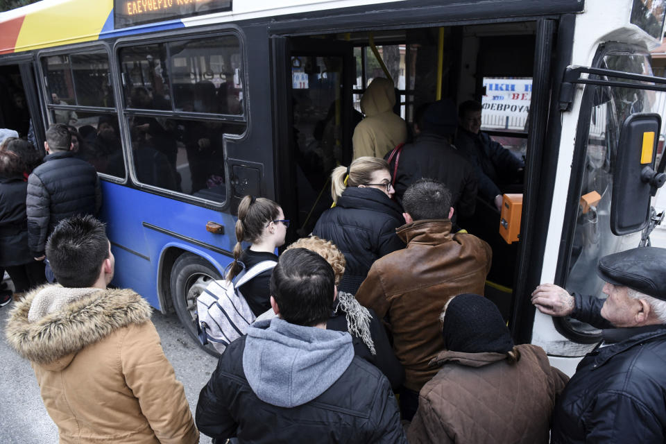 Residents of Kordelio district board a bus after authorities ordered the evacuation of the area in order to defuse a 500-pound unexploded World War II bomb, in Thessaloniki, Greece Sunday, Feb. 12, 2017. Bomb disposal experts are to tackle the device, found buried beneath a gas station, on Sunday in an operation expected to last about six hours, with all residents in a nearly 2-kilometer (1.2-mile) radius being evacuated. (AP Photo/Giannis Papanikos)