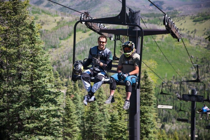 Mountain bikers riding the chairlift at Pajarito Mountain Ski Area.