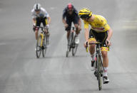 Slovenia's Tadej Pogacar, wearing the overall leader's yellow jersey, looks back to check if he has enough lead on Denmark's Jonas Vingegaard, wearing the best young rider's white jersey, and Richard Carapaz of Ecuador , as he crosses the finish line to win the eighteenth stage of the Tour de France cycling race over 129.7 kilometers (80.6 miles) with start in Pau and finish in Luz Ardiden, France,Thursday, July 15, 2021. (AP Photo/Christophe Ena)