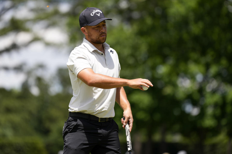 Xander Schauffele waves after making a putt on the fifth hole during the third round of the Wells Fargo Championship golf tournament at the Quail Hollow Club Saturday, May 11, 2024, in Charlotte, N.C. (AP Photo/Chris Carlson)