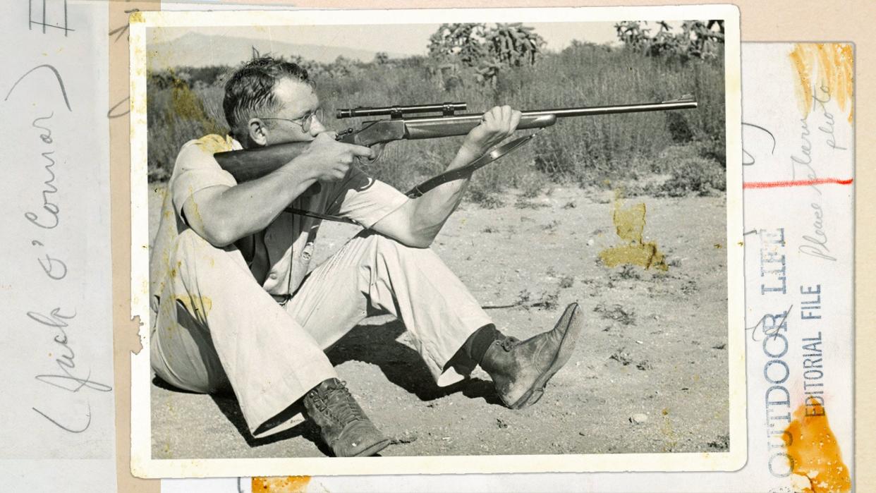 jack o'connor sits and holds rifle