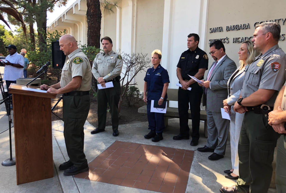 CORRECTS TO SANTA BARBARA COUNTY SHERIFF'S LT. ERIK RANEY, AT PODIUM, ANNOUNCES SPEAKERS AND CLARIFIES THAT BROWN SAYS 18 PEOPLE KILLED IN THE CALIFORNIA DIVE BOAT FIRE HAVE BEEN POSITIVELY IDENTIFIED. Santa Barbara County Sheriff's Lt. Erik Raney, at podium, with Santa Barbara County Sheriff Bill Brown, to his right, announces speakers at a news conference at Sheriff's headquarters in Santa Barbara, Calif., Friday, Sept. 6, 2019. Brown says 18 people killed in the California dive boat fire have been positively identified. Other identifications require DNA analysis because of the intensity of the fire early Monday, Sept. 2, aboard the vessel Conception. (AP Photo/Stefanie Dazio)