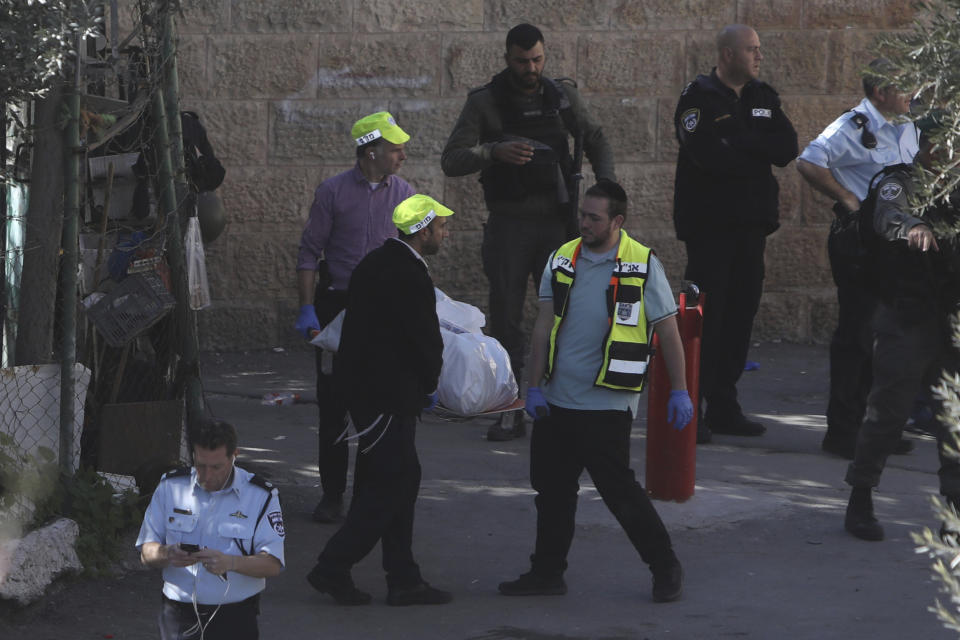 Israeli rescue workers carry the body of a Palestinian man in the Old City of Jerusalem, Thursday, Feb. 6, 2020. Israeli police said they shot and killed the Palestinian who opened fire at forces in Jerusalem's Old City, lightly wounding an officer. (AP Photo/Mahmoud Illean)