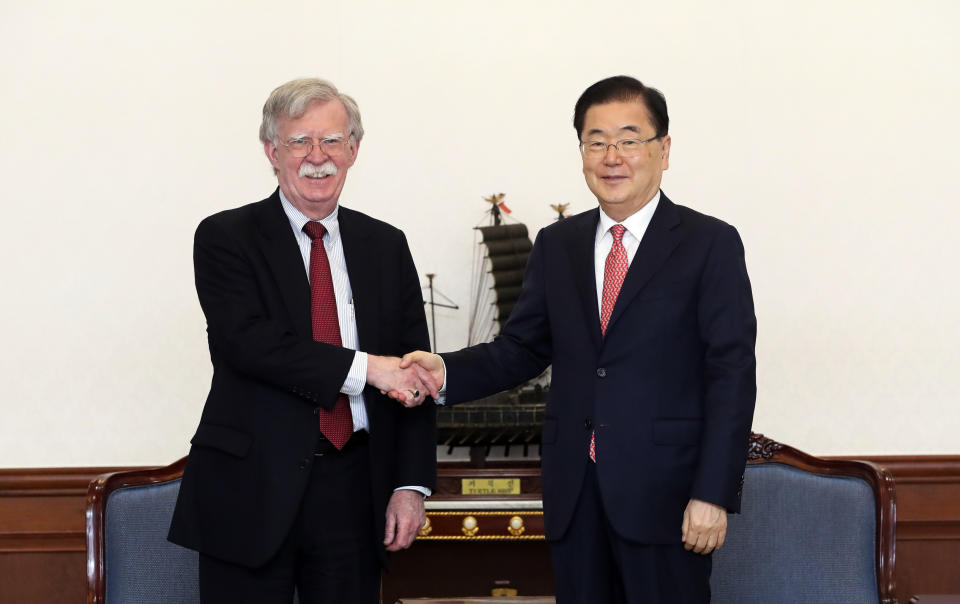 In this photo provided by South Korea Presidential Blue House via Yonhap News Agency, U.S. National Security Advisor John Bolton, left, shakes hands with South Korean National Security Advisor Chung Eui-yong during a meeting at the presidential Blue House in Seoul, South Korea, Wednesday, July 24, 2019. (South Korea Presidential Blue House/Yonhap via AP)