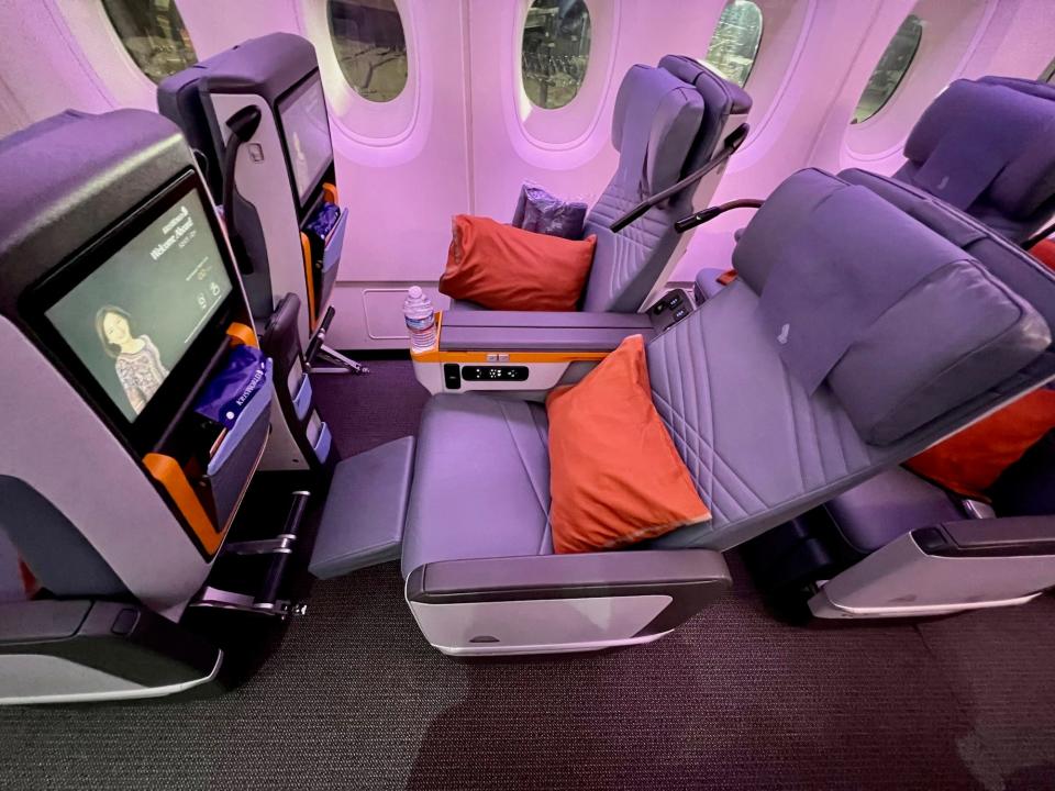 One of the premium economy seats in the fully reclined position.