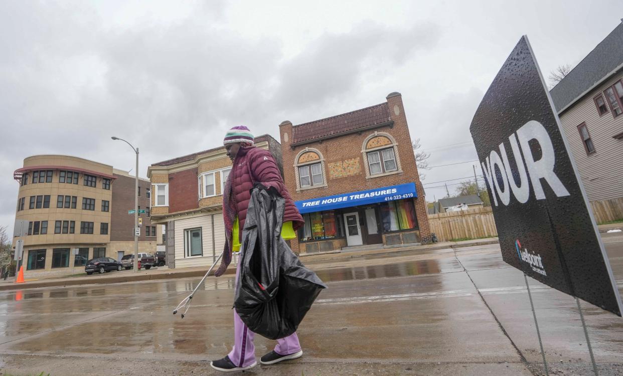 Latrice Griffin picks up trash during the clean up hosted by United Methodist Children's Services of Wisconsin, Inc., April 22,  at Sarnow Triangle located at 3817 W. Lisbon Ave., Milwaukee.