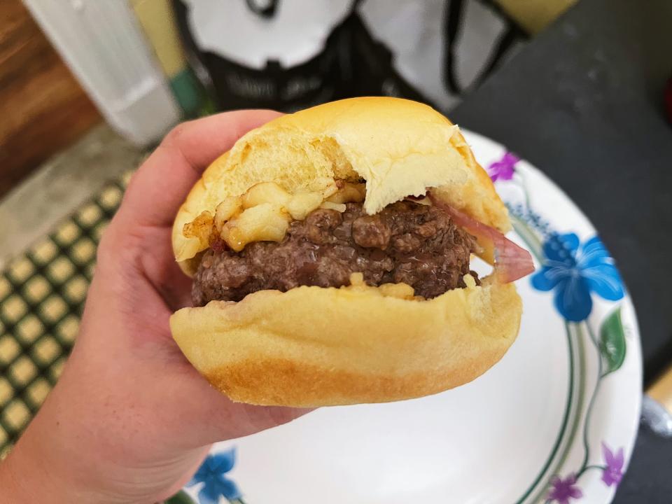 a person holding a burger