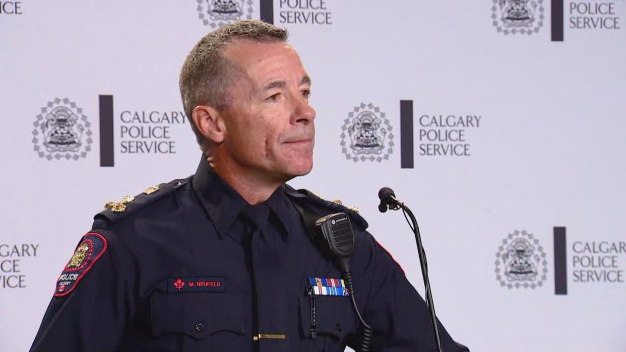 As the legal representative of the Calgary Police Service, Chief Mark Neufeld is suing the service's former HR director Angela Whitney, alleging she breached a severance agreement. On Tuesday, a judge agreed that Whitney made inappropriate posts and issued an injunction against the former employee.  (CBC - image credit)