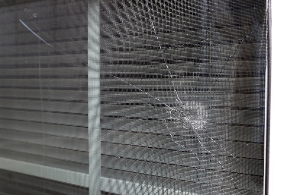 A bullet hole from the police officer's shot is seen in the rear window of Atatiana Jefferson's home in Fort Worth, Texas, Tuesday, Oct. 15, 2019. Jefferson, a black woman, was shot by a white police officer early Saturday, Oct. 12. Black politicians and activists criticized the police and the media for bringing up Jefferson's weapon, angrily accusing the department of trying to deflect blame onto an innocent victim. ( (AP Photo/Tony Gutierrez)