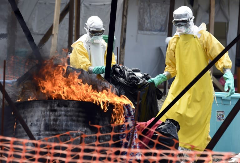 Liberian health workers burn clothes belonging to patients at an Ebola clinic in Monrovia, as the virus raged West Africa in 2014