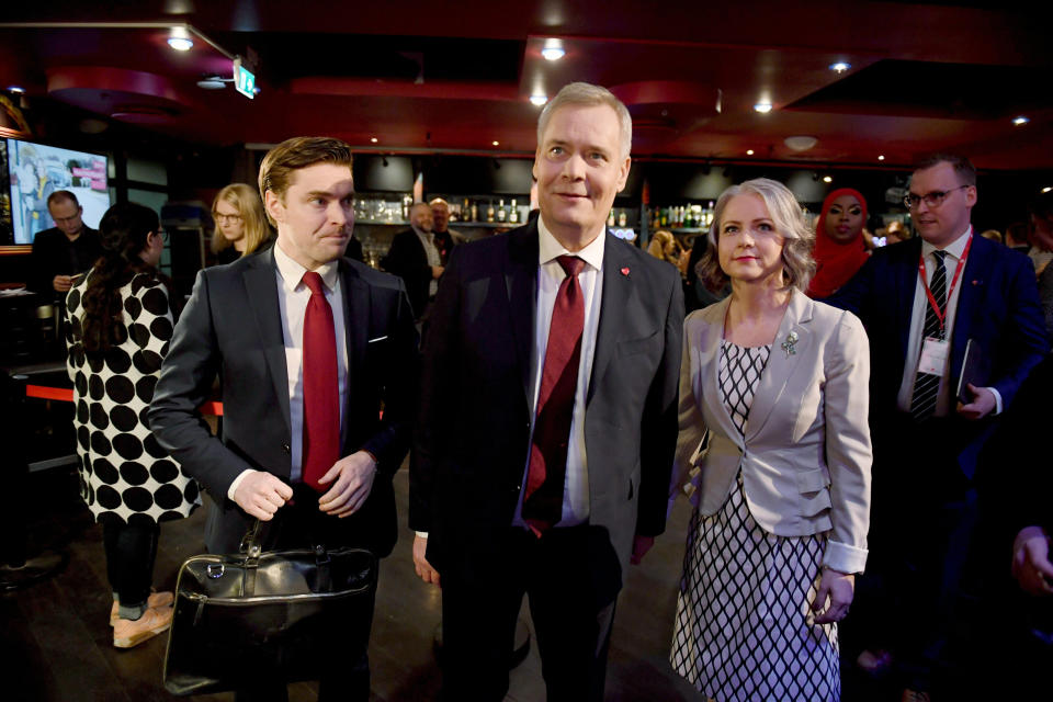 Chairman of the Finnish Social Democratic Party Antti Rinne, centre, with his wife Heta Ravolainen-Rinne, right, and the Party's communications representative Dimitri Qvintus, at the parliamentary election party in Helsinki, Sunday, April 14, 2019. Voters in Finland are casting ballots in a parliamentary election Sunday after climate change dominated the campaign, even overshadowing topics like reforming the nation's generous welfare model. (Antti Aimo-Koivisto/Lehtikuva via AP)