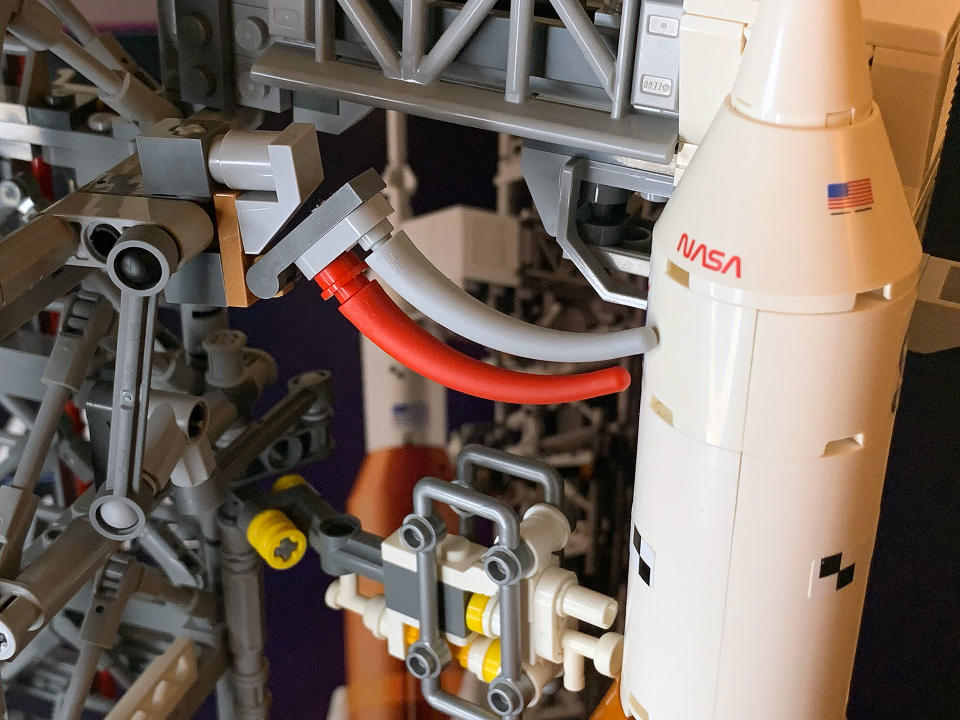 The snakes on the umbilical cord of the Orion maintenance module are represented in the Lego Icons NASA Artemis Space Launch System by red and gray dinosaur tails first produced for an earlier set.