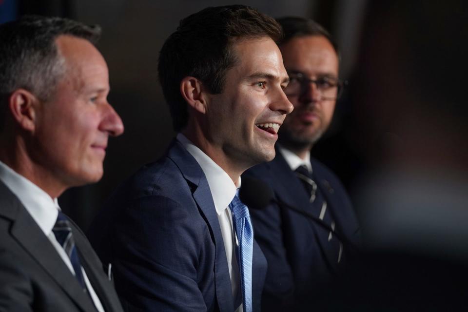 Detroit Tigers' new president of baseball operations Scott Harris, center, speaks during his introductory news conference Tuesday, Sept. 20, 2022 at Comerica Park in downtown Detroit. He is flanked by Tigers owner Christopher Ilitch (left) and Ilitch Sports and Entertainment president Chris McGowan.