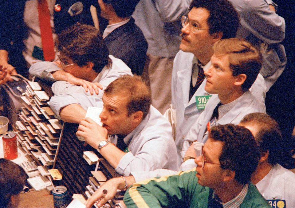 Traders at the American Stock Exchange watch with anticipation the market activity in New York, Oct. 26, 1987. The market closed down in a shortened trading session which is designed to give the market a chance to catch up on paperwork. 