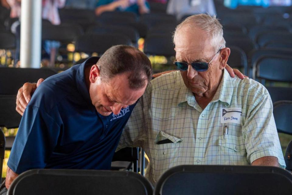 Attendants pray together at the Prayer at the Heart of America event in Lebanon, Kansas, Friday, July 22, 2021. Throughout the event speakers prayed for forgiveness and healing of America.