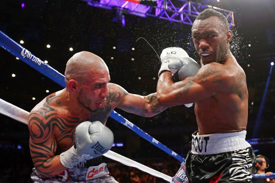 NEW YORK, NY - DECEMBER 01: Miguel Cotto (L) connects on a punch while fighting against Austin Trout in their WBA Super Welterweight Championship title fight at Madison Square Garden on December 1, 2012 in New York City. (Photo by Elsa/Getty Images)