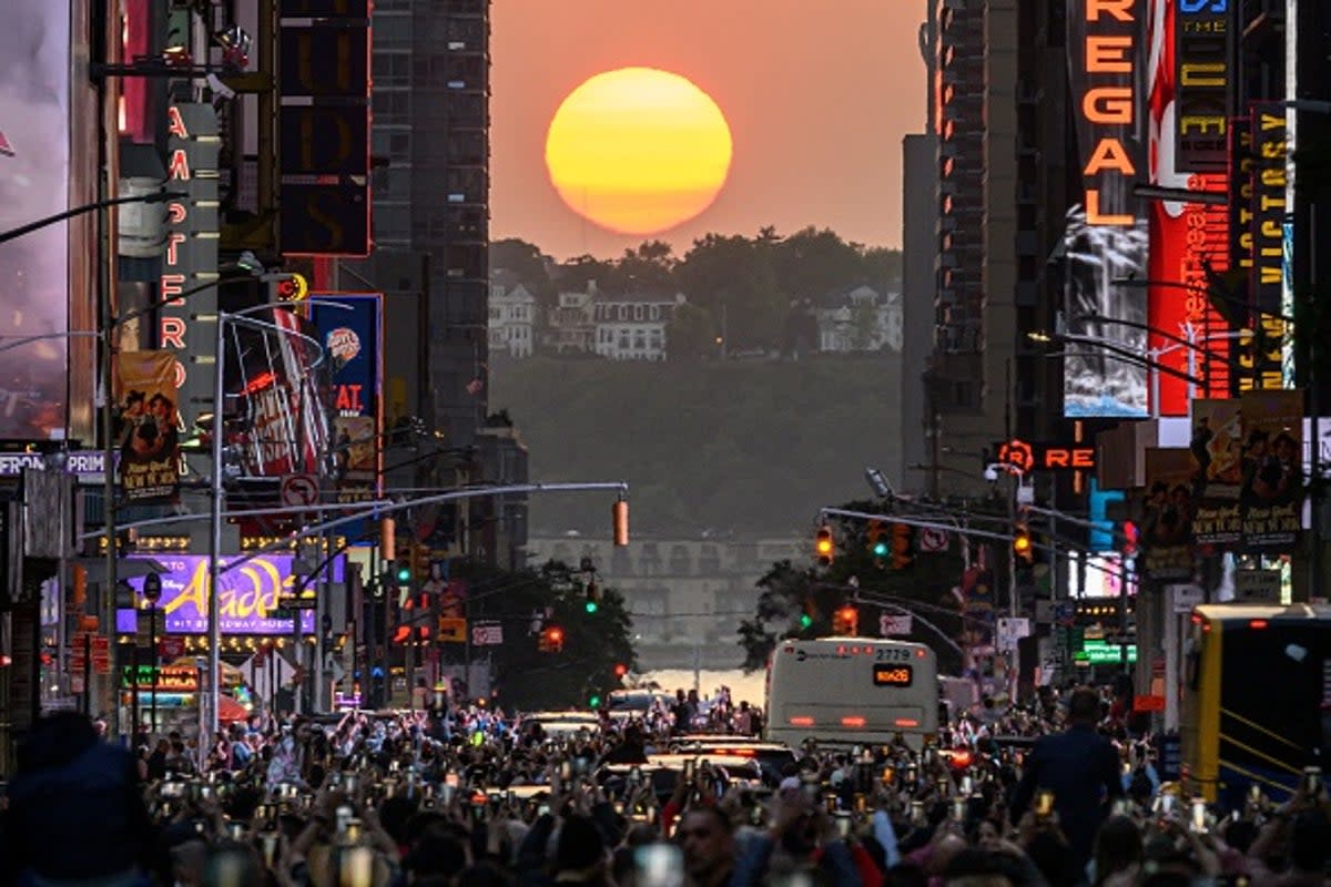 Manhattanhenge is when the sunset and New York City’s streets perfectly align  (AFP via Getty)