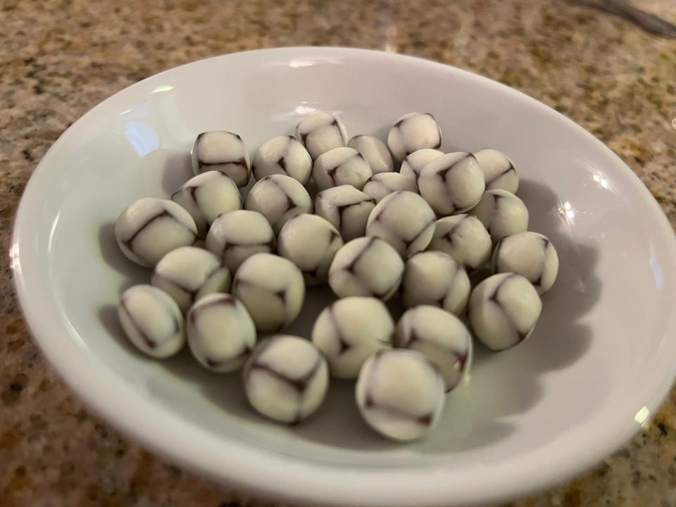 Tiny yogurt balls in a white bowl