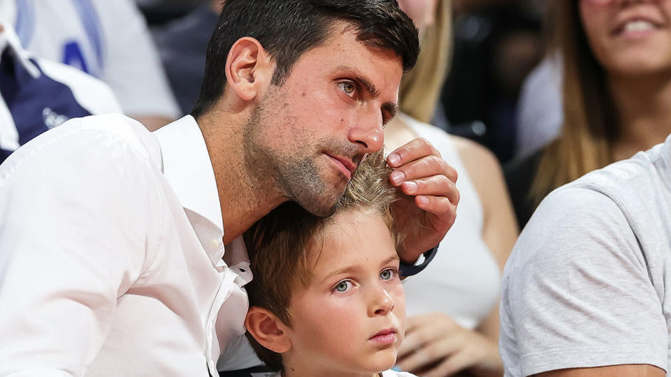 Novak Djokovic is seen here with his son watching a basketball game.
