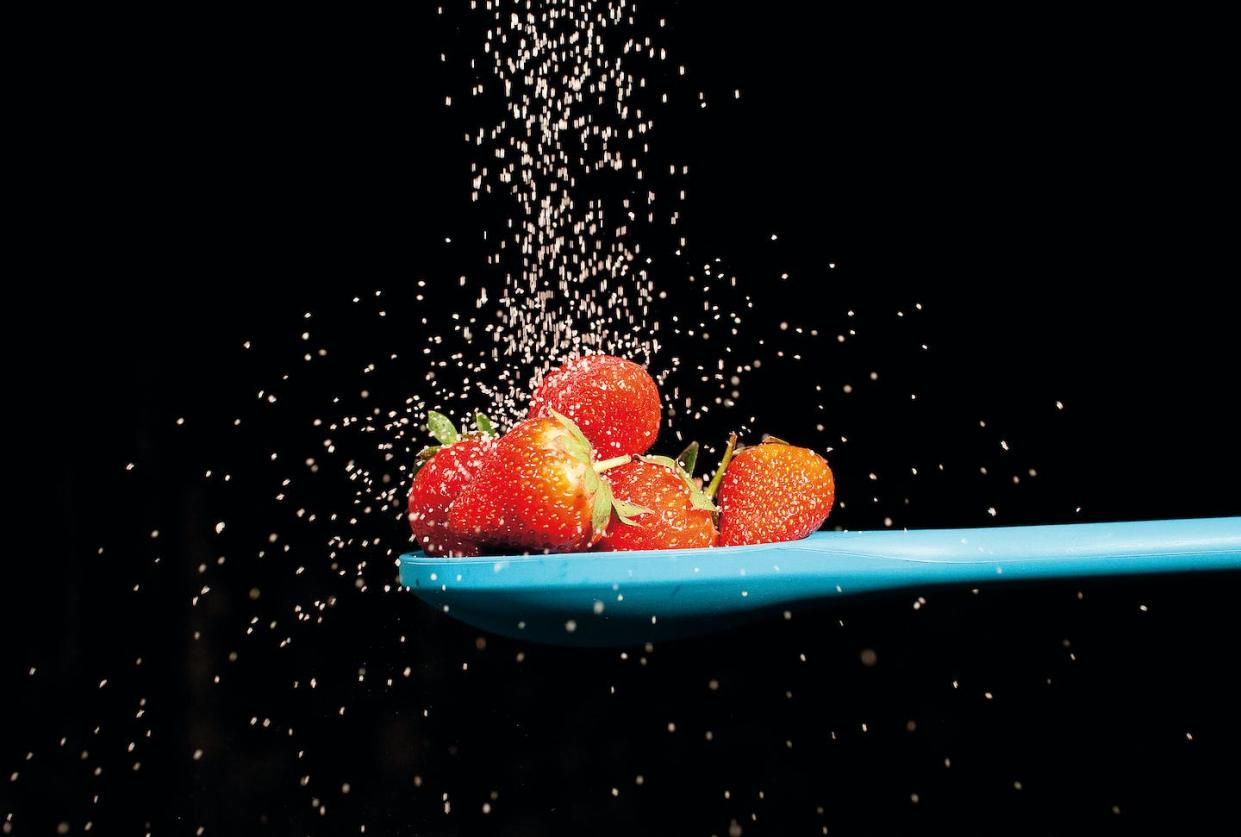 Ripe berries and sugar crystals are both sweet, but one offers much more than just calories. <a href="https://www.gettyimages.com/detail/news-photo/sugar-sprinkling-down-onto-a-spoonful-of-strawberries-taken-news-photo/138203565" rel="nofollow noopener" target="_blank" data-ylk="slk:Chris George/PhotoPlus Magazine/Future via Getty Images;elm:context_link;itc:0;sec:content-canvas" class="link ">Chris George/PhotoPlus Magazine/Future via Getty Images</a>