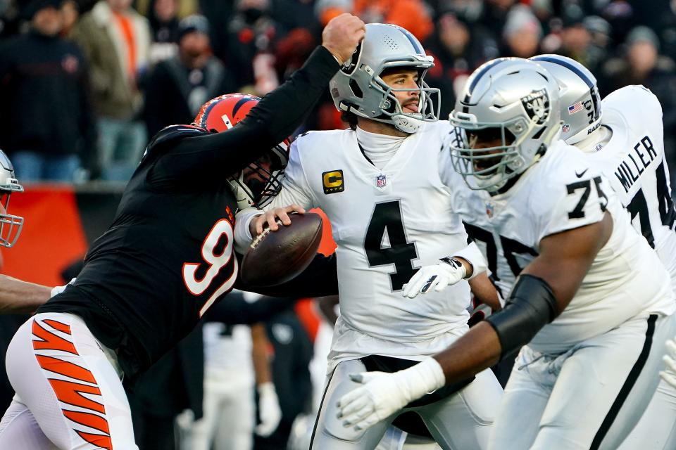 Cincinnati Bengals defensive end Trey Hendrickson (91) causes a sack and fumble of Las Vegas Raiders quarterback Derek Carr (4) in the first quarter during an NFL AFC wild-card playoff game, Saturday, Jan. 15, 2022, at Paul Brown Stadium in Cincinnati.