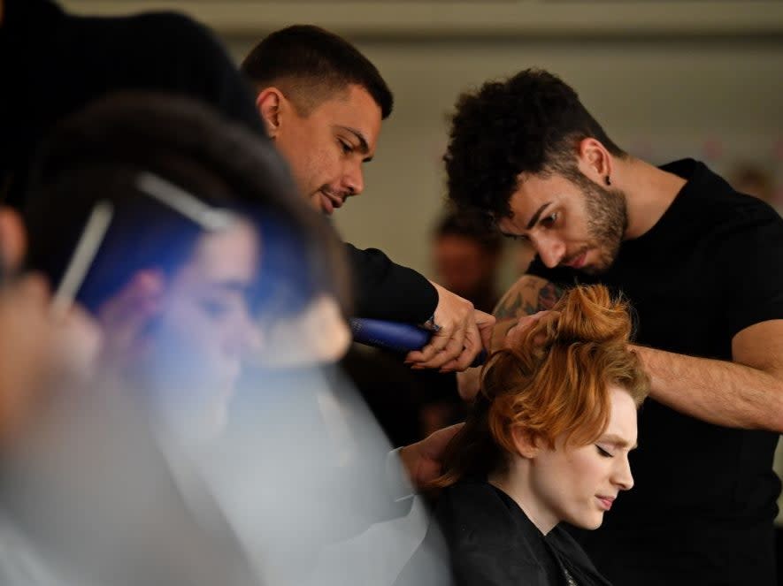 Models have their hair and make-up prepared before presenting creations by fashion house Richard Quinn during the catwalk show for their Autumn/Winter 2020 collection on the second day of London Fashion Week in London (AFP via Getty Images)