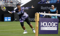 Serena Williams of the United States, left, returns the ball as Ons Jabeur of Tunisia looks on during their doubles tennis match against Marie Bouzkova of Czech Republic and Sara Sorribes Tormo of Spain at the Eastbourne International tennis tournament in Eastbourne, England, Tuesday, June 21, 2022. (AP Photo/Kirsty Wigglesworth)