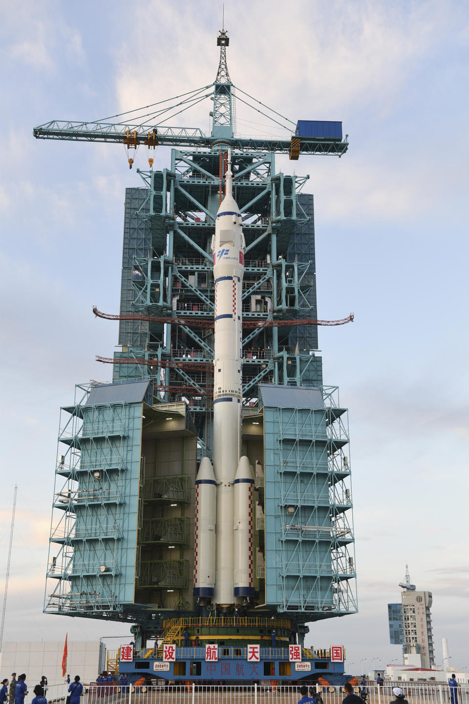 In this photo released by Xinhua News Agency, the Shenzhou-12 manned spaceship with its Long March-2F carrier rocket is being prepared at the launching area of Jiuquan Satellite Launch Center in northwestern China Gansu province, on Wednesday, June 9, 2021. A three-man crew of astronauts will blast off in June for a three-month mission on China's new space station, according to a space official who was the country's first astronaut in orbit in May. (Wang Jiangbo/Xinhua via AP)
