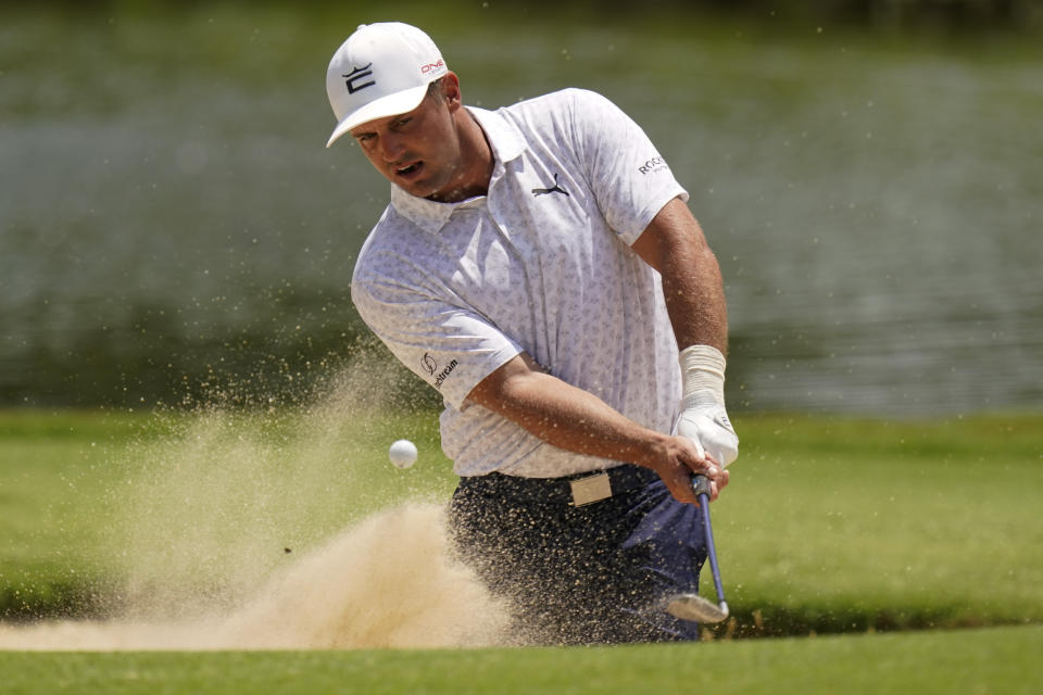 Bryson Dechambeau hits from the bunker on the 13th hole during a practice round for the PGA Championship golf tournament, Wednesday, May 18, 2022, in Tulsa, Okla. (AP Photo/Eric Gay)