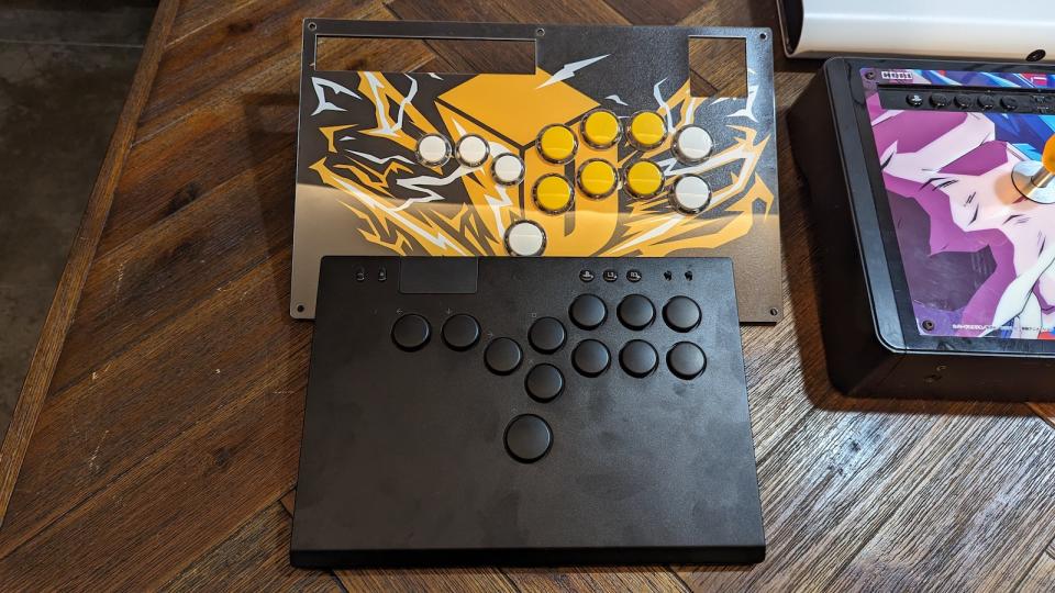 The Razer Kitsune with another version of a all-button controller on a wooden table