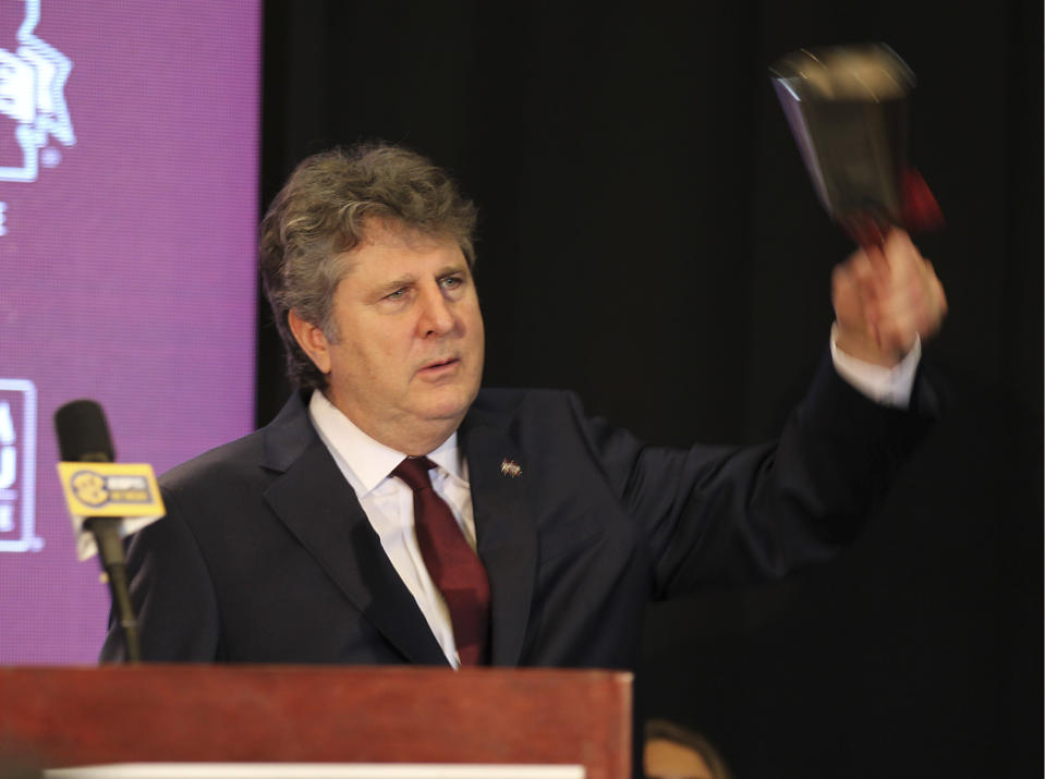 New Mississippi State University head football coach Mike Leach rings his cowbell one last time before leaving stage before reporters and school supporters, Friday, Jan. 10, 2020, at the Starkville, Miss., based university, after being officially introduced as the head coach. (AP Photo/Rogelio V. Solis)