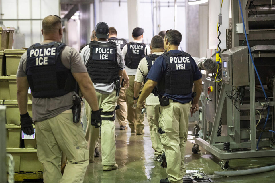 Homeland Security Investigations (HSI) officers from Immigration and Customs Enforcement (ICE) look on after executing search warrants and making arrests at an agricultural processing facility in Canton, Mississippi, on Aug. 7. (Photo: Reuters)