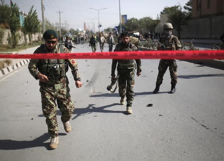 Afghan security personnel leave the site of a suicide car bomb blast in Kabul, Afghanistan October 11, 2015. REUTERS/Ahmad Masood