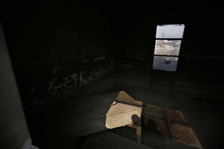 The interior of a damaged house is pictured inside an abandoned steel mill of Qingquan Steel Group in Qianying township, Hebei province February 18, 2014. REUTERS/Petar Kujundzic