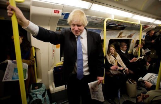 London Mayor Boris Johnson travels on a London underground train in north London on May 3, 2012. A cable car has been strung over the Thames, an athletes' terminal built at Heathrow Airport, and Olympic traffic lanes set up -- yet Londoners still fear the Games will bring their city to a standstill