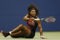 Serena Williams of the U.S. follows the flight of the ball as she falls on a return shot to her sister and compatriot Venus Williams during their quarterfinals match at the U.S. Open Championships tennis tournament in New York, September 8, 2015. REUTERS/Shannon Stapleton