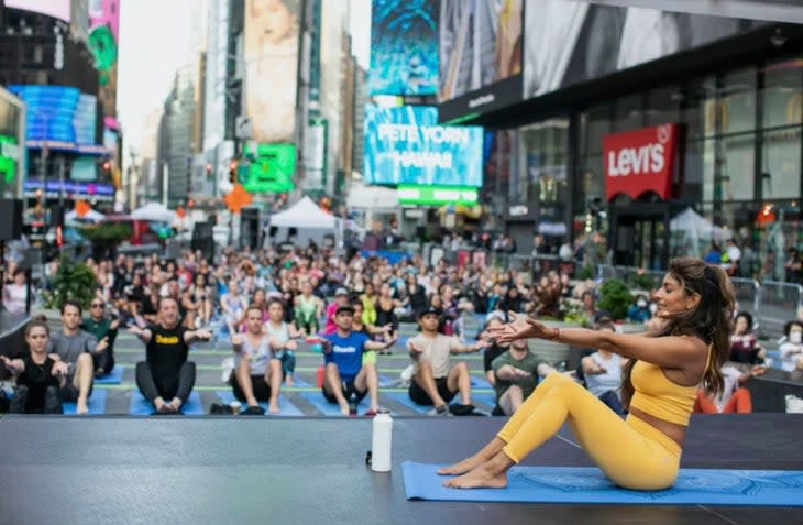 <span class="article__caption">Outside hosts a "Solstice in Times Square" yoga session as part of the NFT.NYC conference. (Photo: Darren Miller)</span>